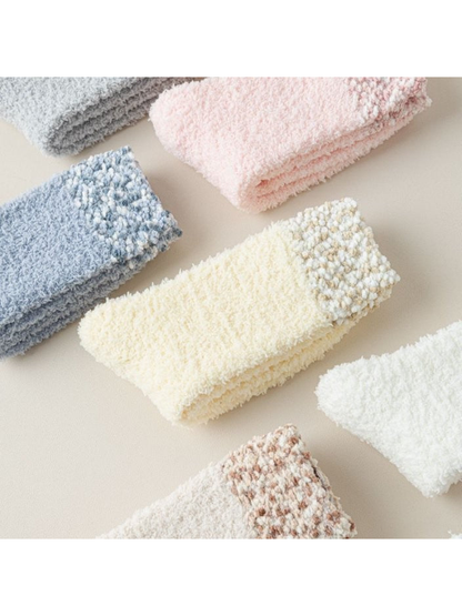 Close-up of fuzzy socks with contrasting bobble-textured cuffs