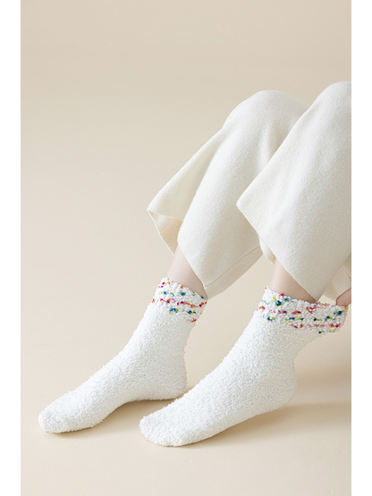 Multicolor fuzzy crew socks worn with cream pants