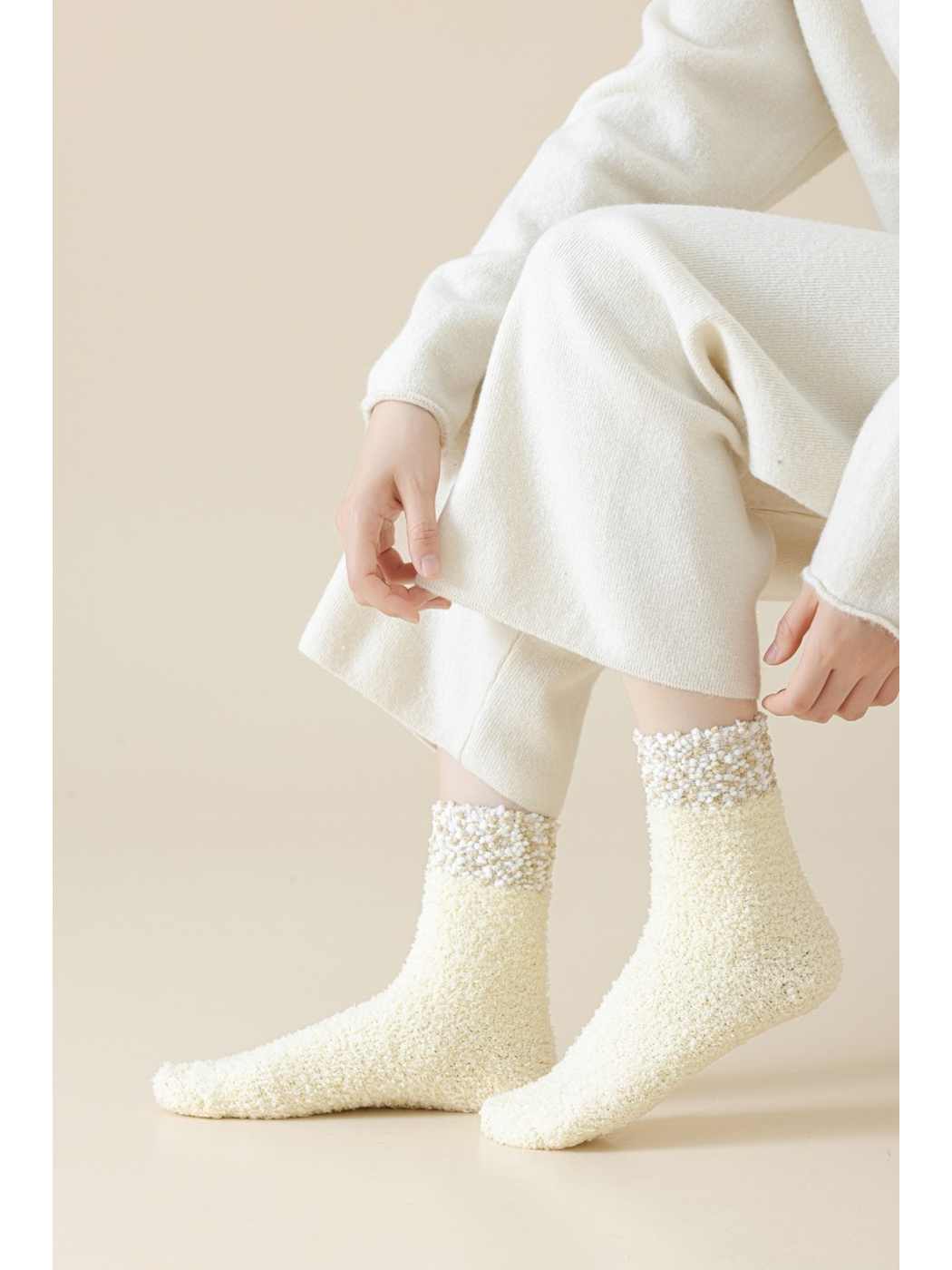 Cream Ivory fuzzy crew socks worn with cream pants