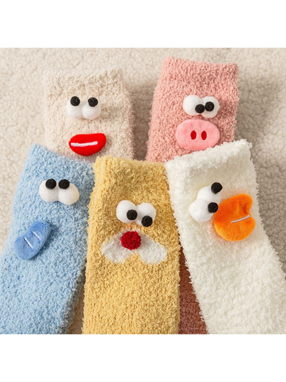 Close-up of fuzzy sock texture and raised cartoon face appliques