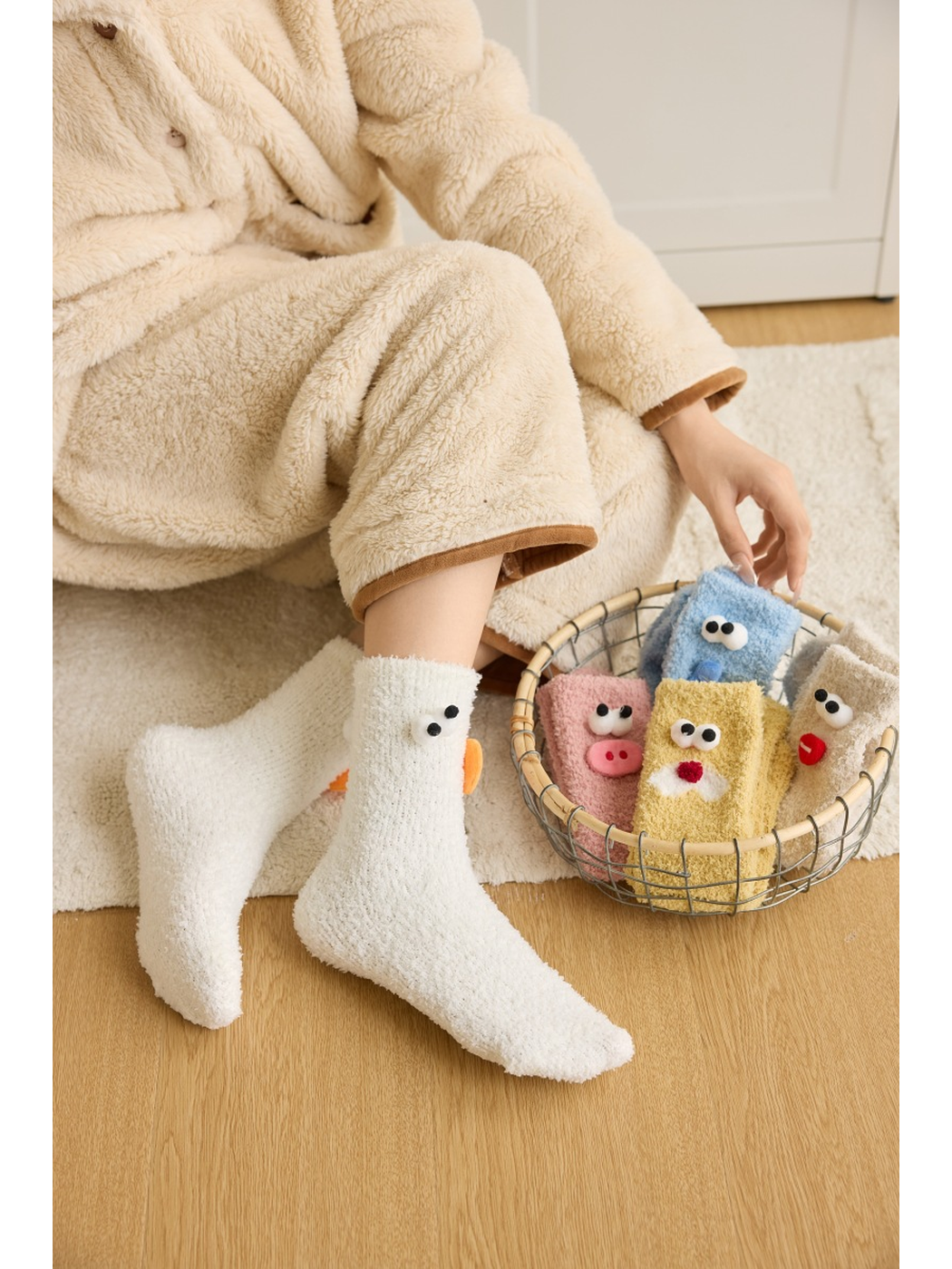 White cartoon duck socks worn beside a basket of assorted colors