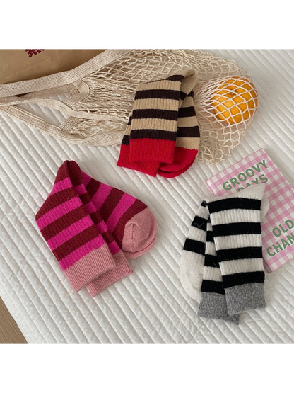 Fuchsia, brown and black striped crew socks arranged in pairs