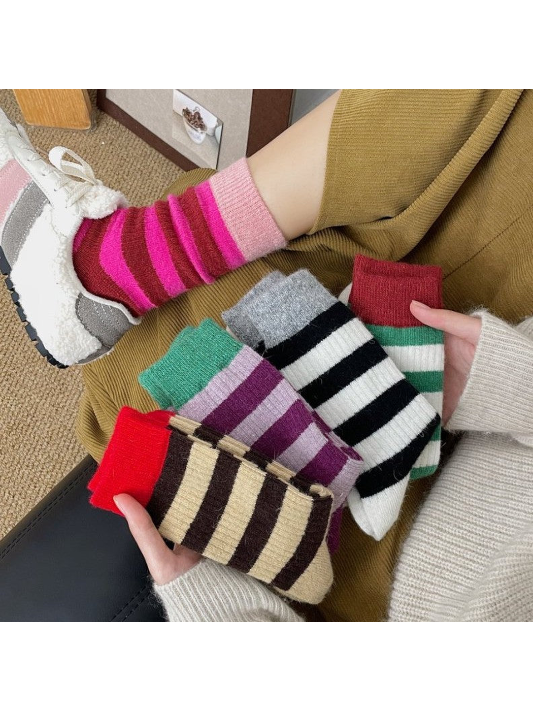 Colorful striped crew socks displayed with one style worn