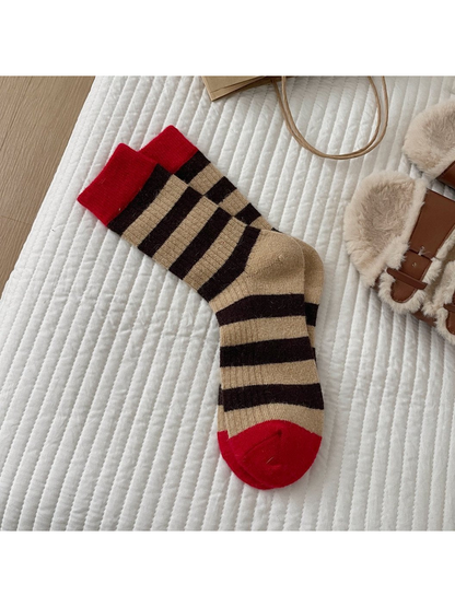 Brown striped crew socks with red cuffs and toes