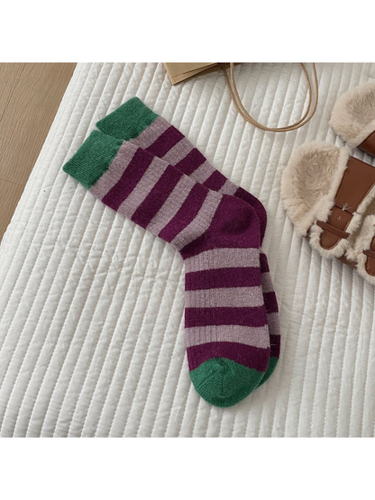 Purple striped crew socks with green cuffs and toes