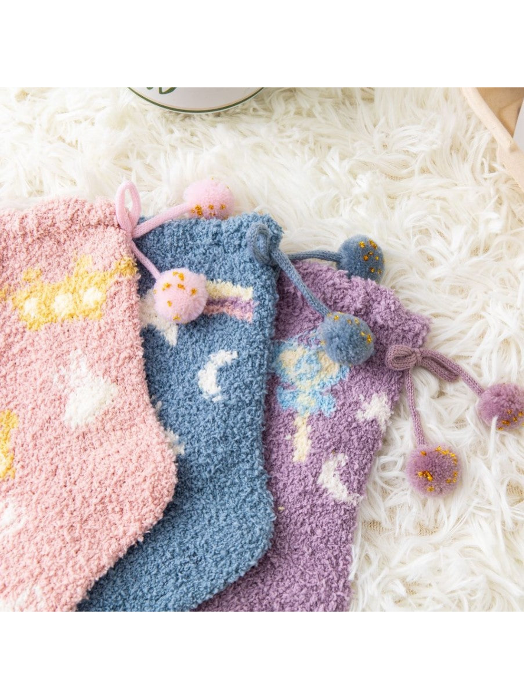 Close-up of colorful fuzzy socks with pom-pom cuff ties