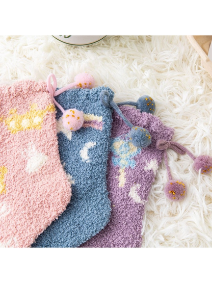 Close-up of colorful fuzzy socks with pom-pom cuff ties