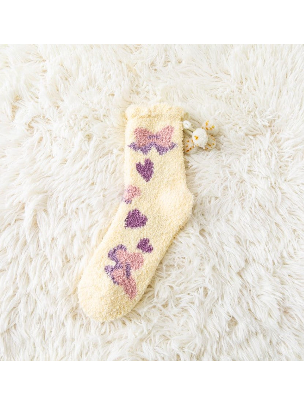 Yellow fuzzy crew sock with bow and heart motifs