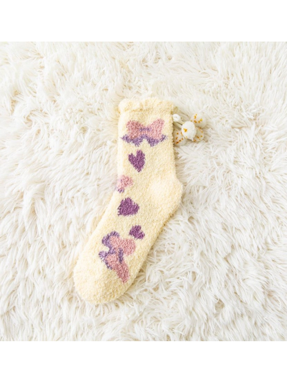 Yellow fuzzy crew sock with bow and heart motifs