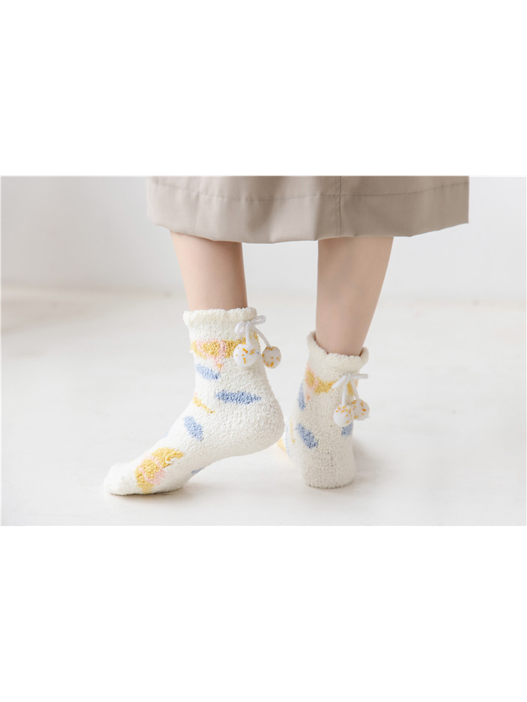 Ivory fuzzy crew socks with colorful motifs, standing view