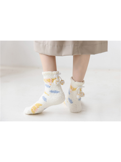 Ivory fuzzy crew socks with colorful motifs, standing view