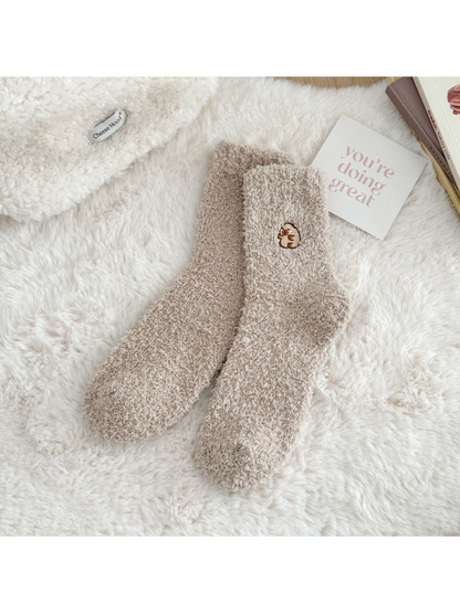 Khaki fuzzy crew socks with a small embroidered animal motif