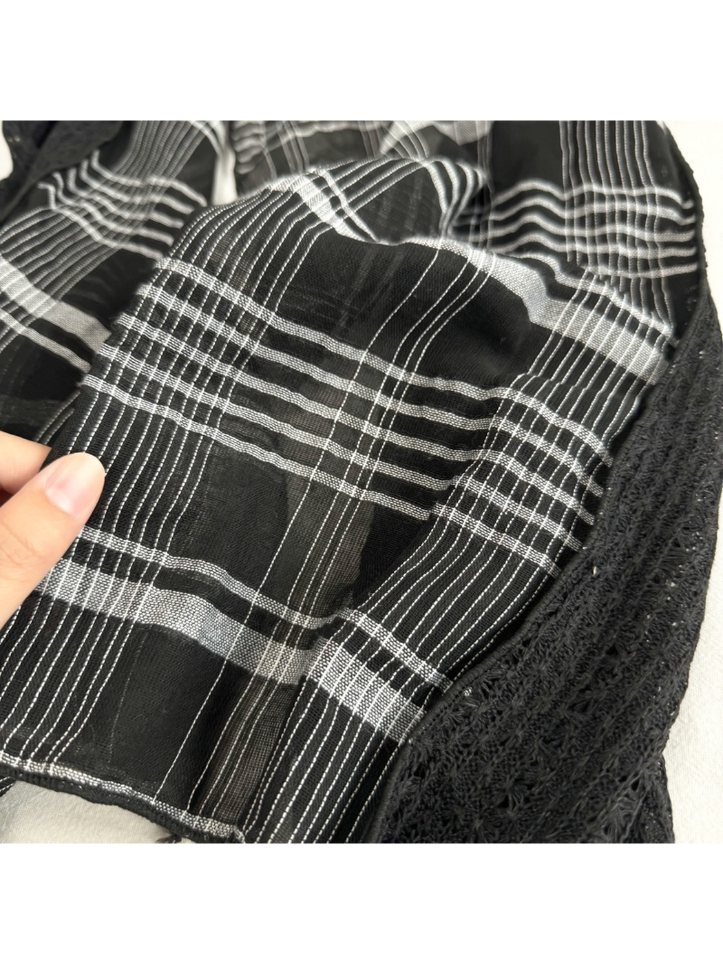 Close-up of the Black plaid pattern beside the openwork panel