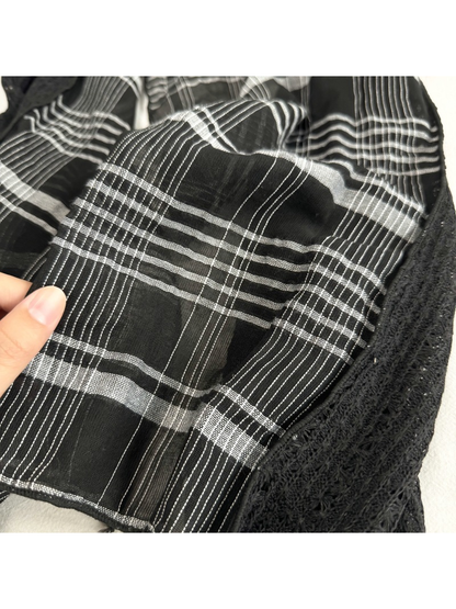 Close-up of the Black plaid pattern beside the openwork panel