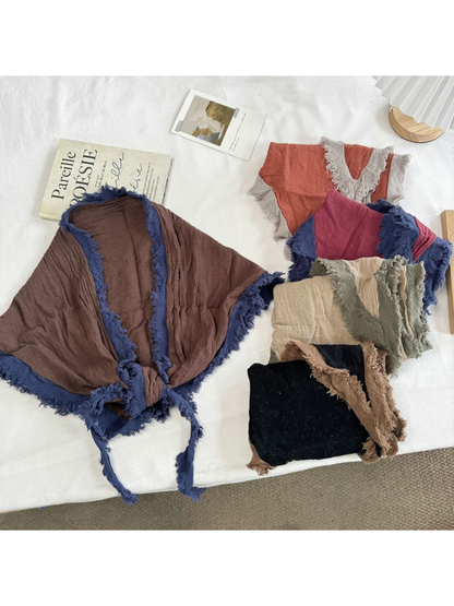 Multiple two-tone triangle scarf styles displayed together