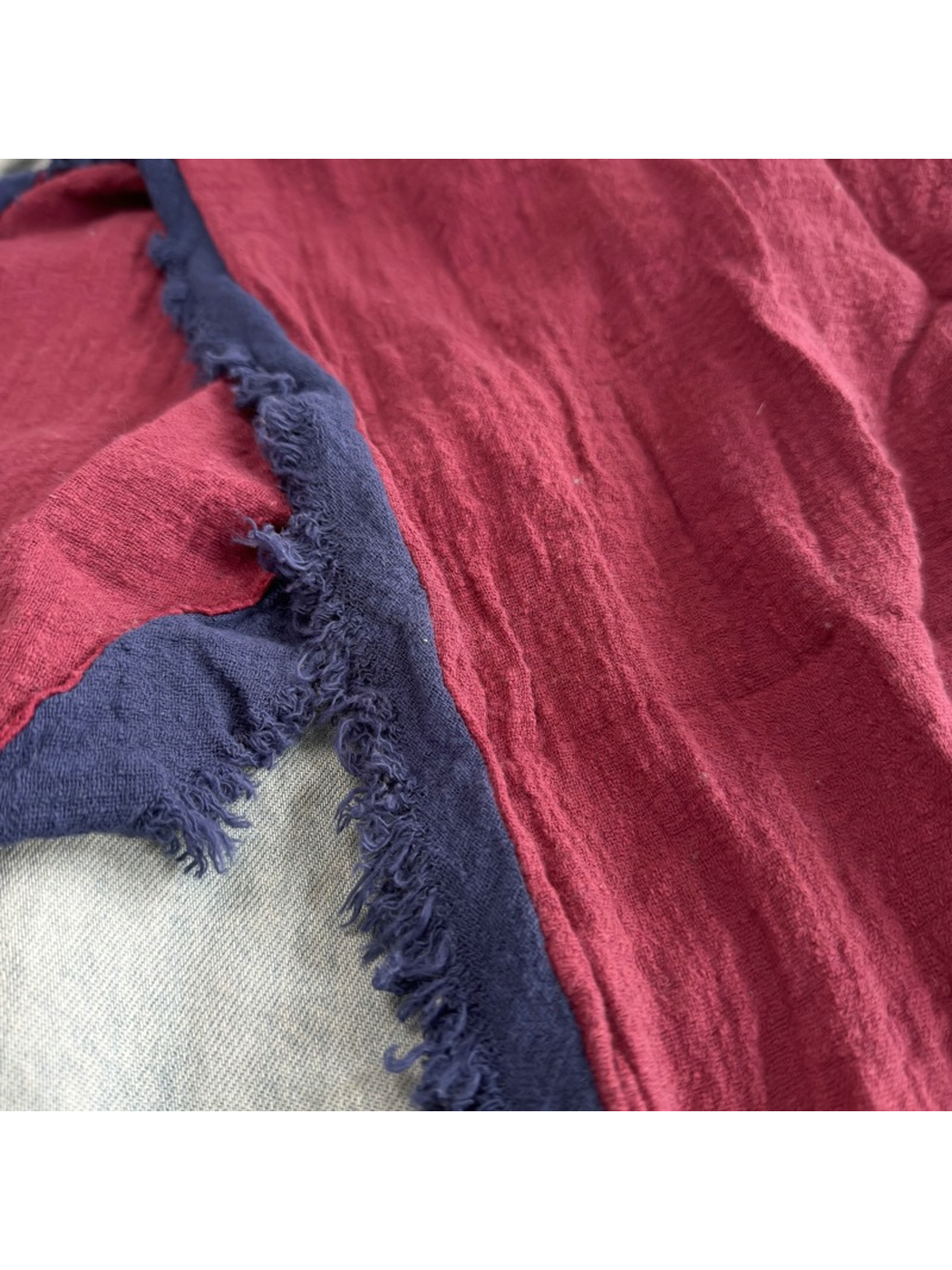 Close-up of the Burgundy Navy scarf's crinkled texture and fringed edge