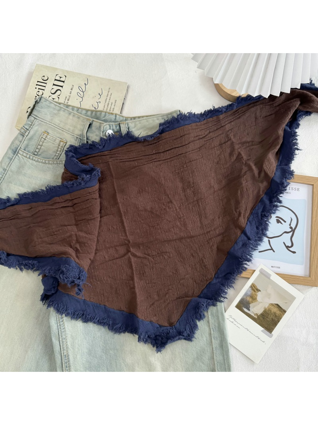 Brown Navy triangle scarf spread open to show its fringed border and long tie ends