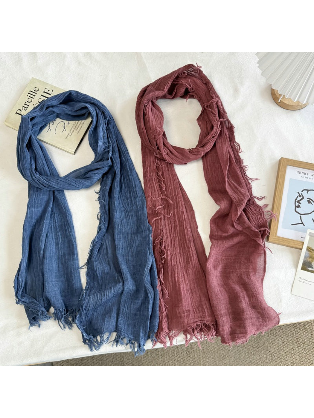 Blue and burgundy crinkled scarves displayed side by side