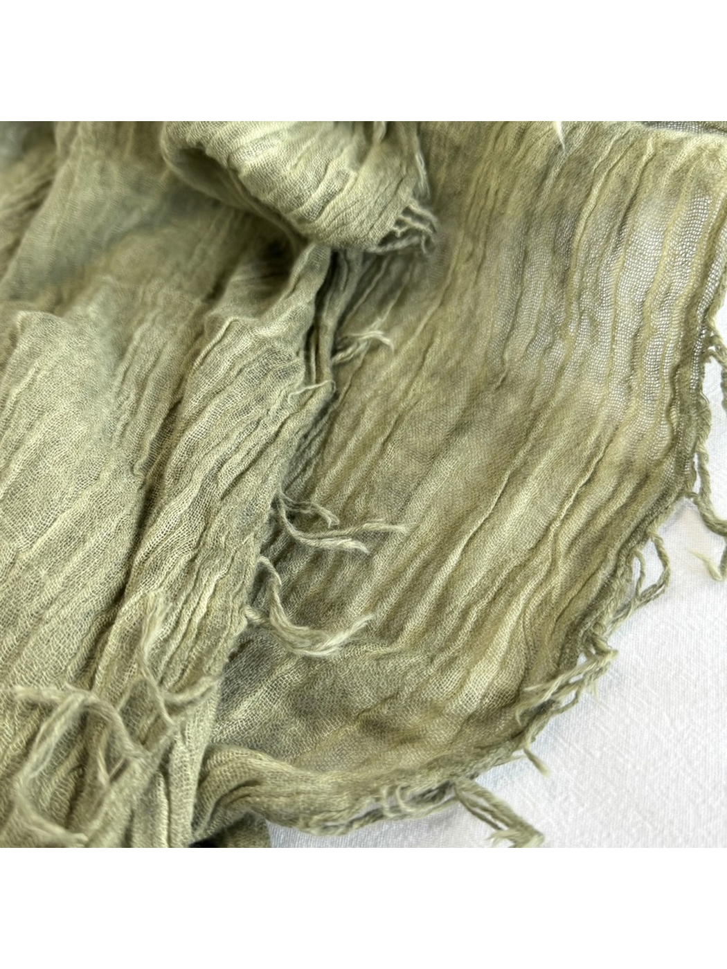 Close-up of the Army Green scarf texture and fringed edge