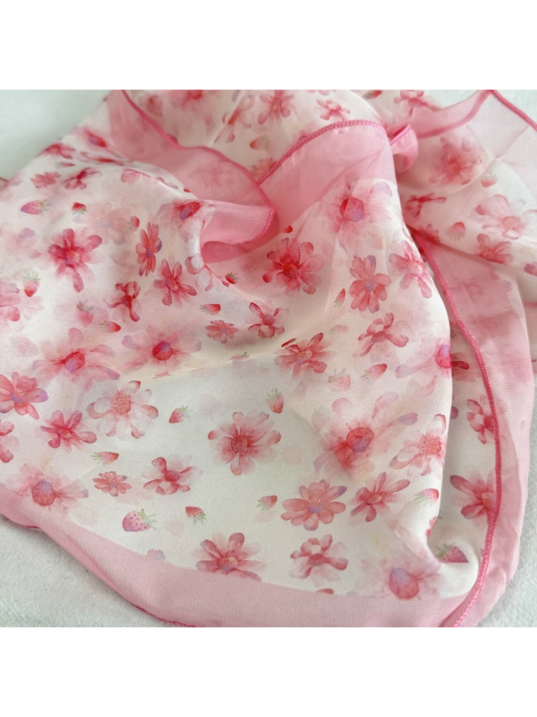 Close-up of pink blossom print and pink stitched edge