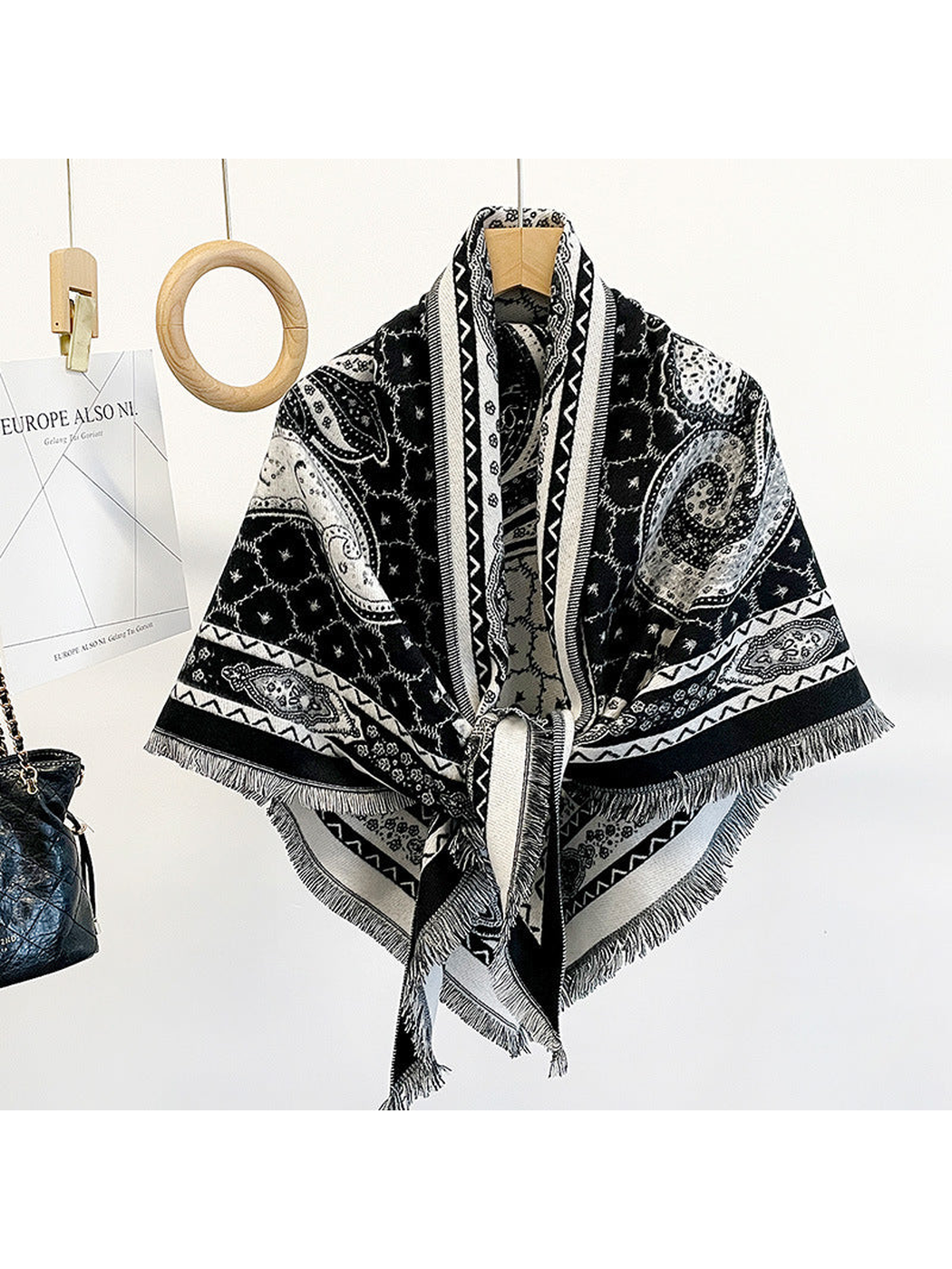 Black paisley triangle scarf draped on a hanger