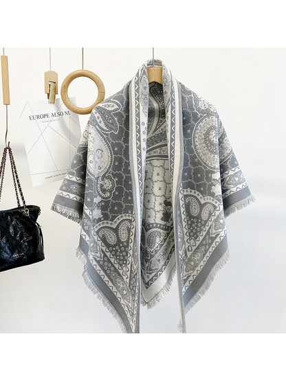 Gray paisley triangle scarf draped on a hanger