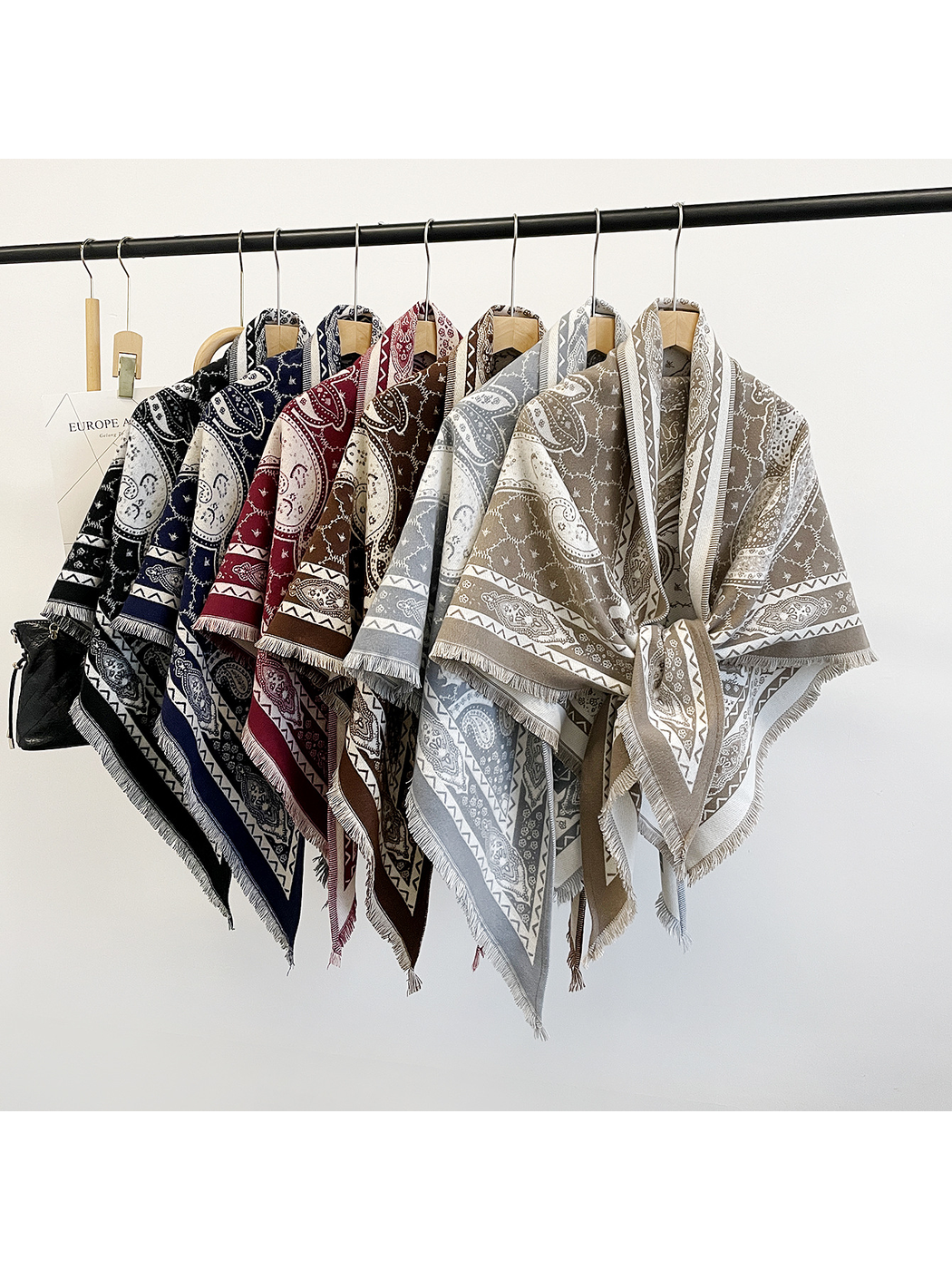 Six paisley triangle scarf colors displayed together on hangers