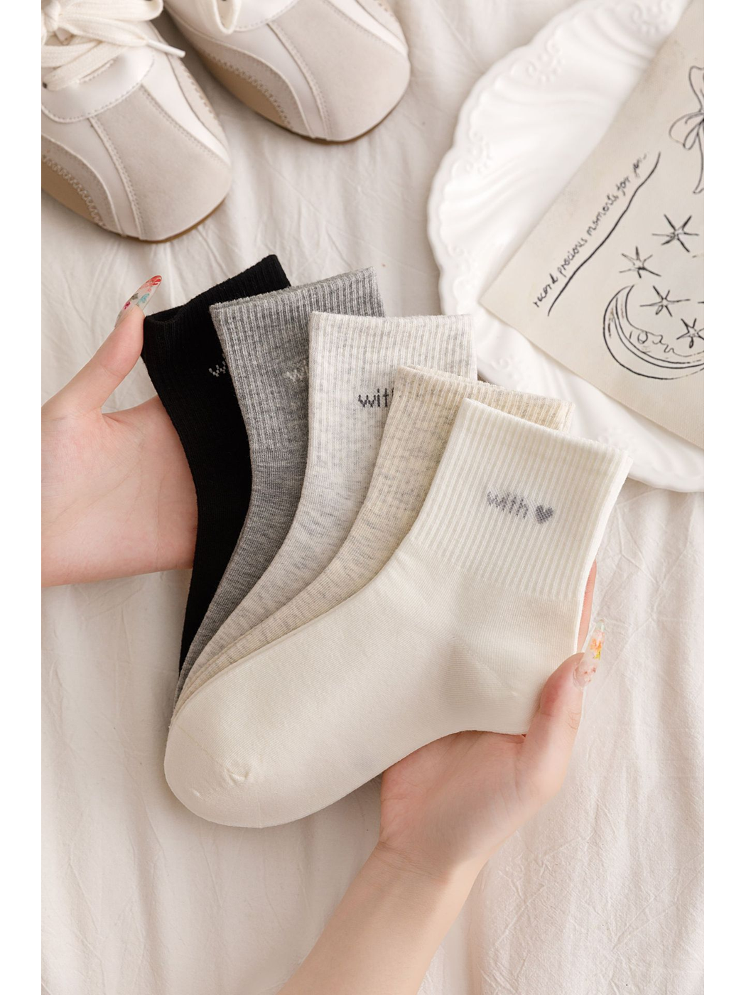 Ivory, beige, light gray, gray and black ankle socks displayed together