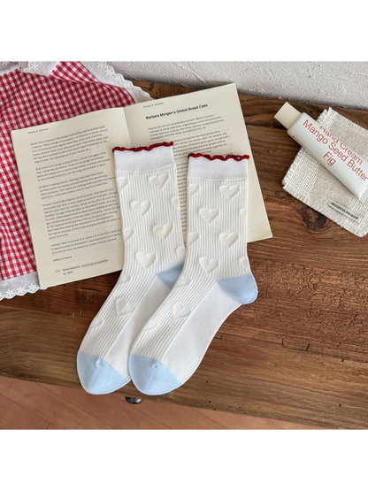 Hearts style white ribbed crew socks with raised heart motifs and light blue toes and heels