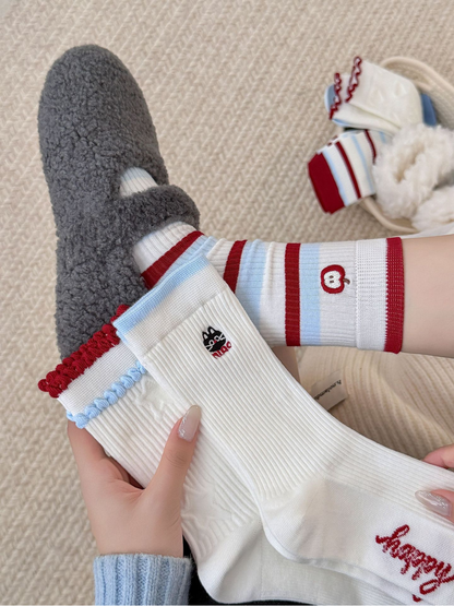 Apple style striped crew socks worn with gray slippers