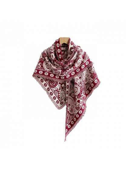 Red paisley triangle scarf with fringed edges on a white background