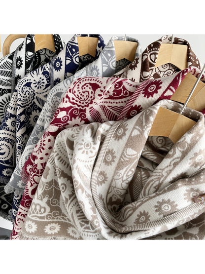 Paisley triangle scarves in multiple colors displayed on hangers