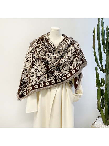 Brown paisley triangle scarf draped on a mannequin