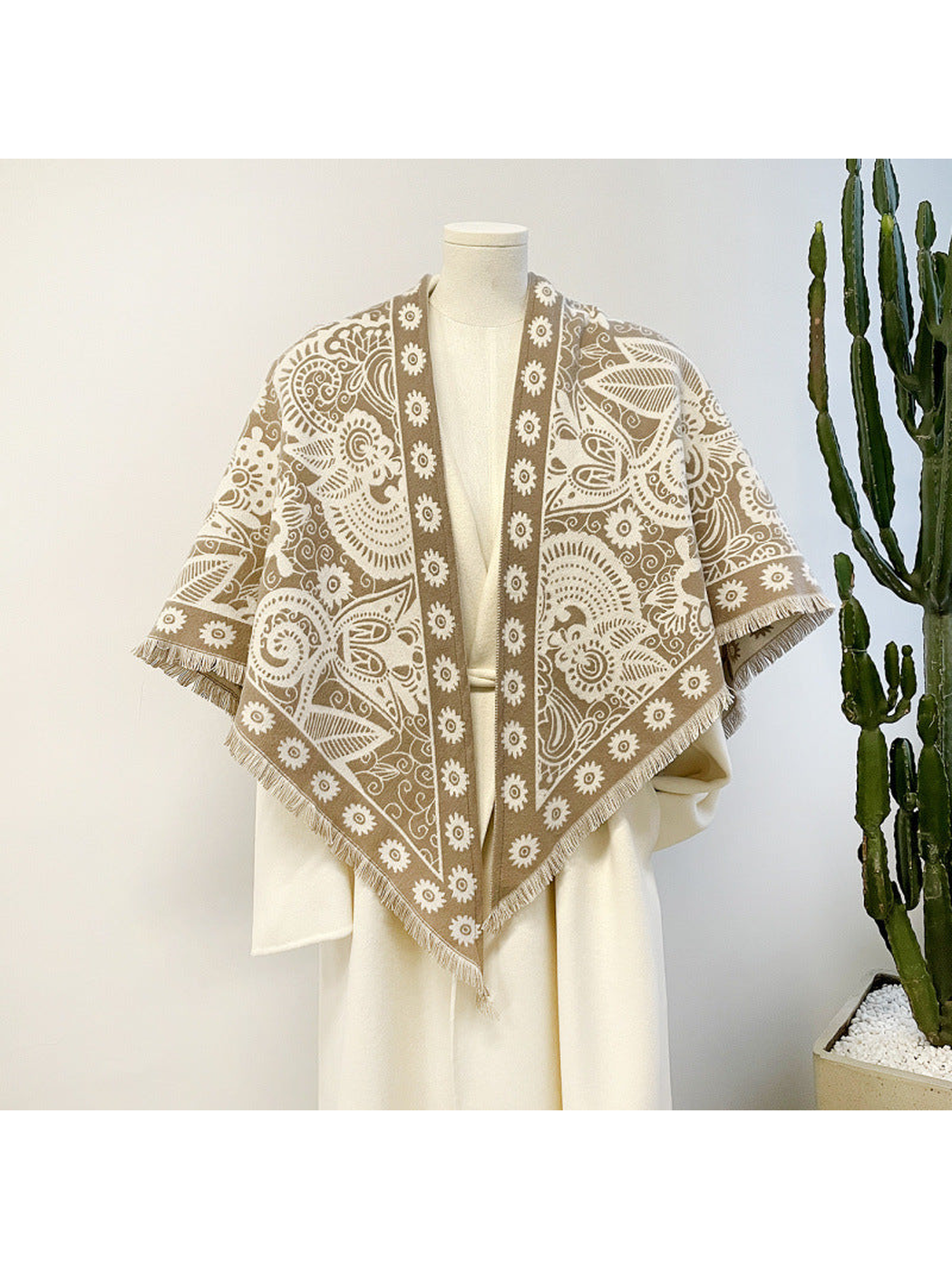 Khaki paisley triangle scarf draped on a mannequin