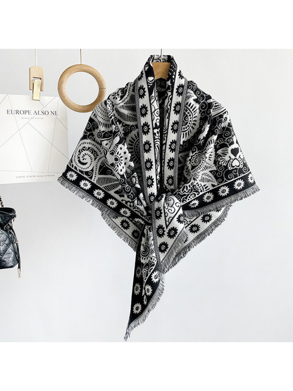 Black paisley triangle scarf draped on a hanger