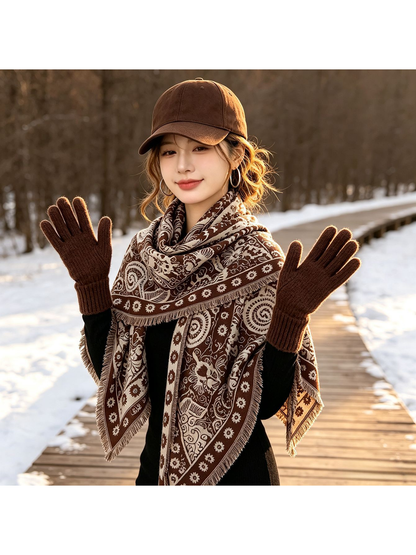 Brown paisley triangle scarf worn over a dark top in a snowy outdoor setting
