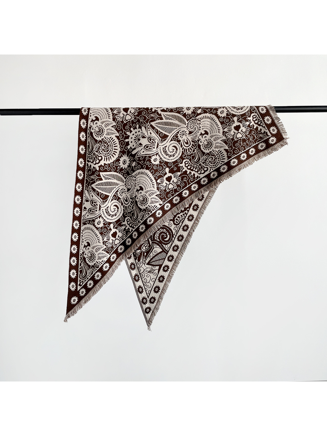 Brown paisley triangle scarf unfolded to show the floral border and short fringe
