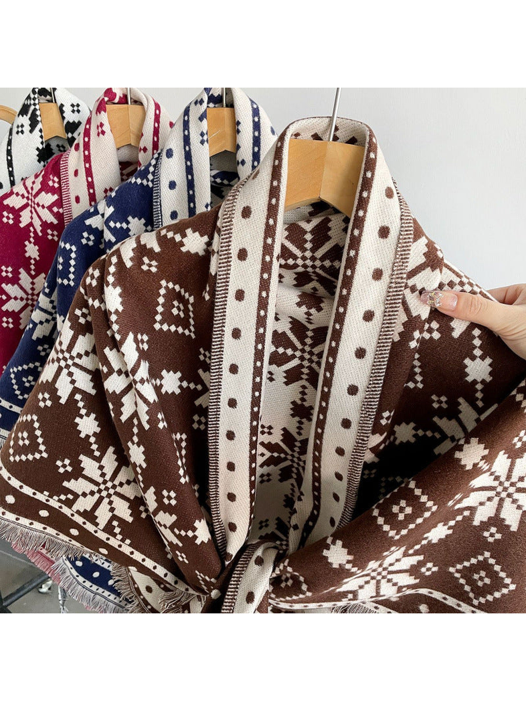 Burgundy, navy, black, and dark brown snowflake scarves displayed together