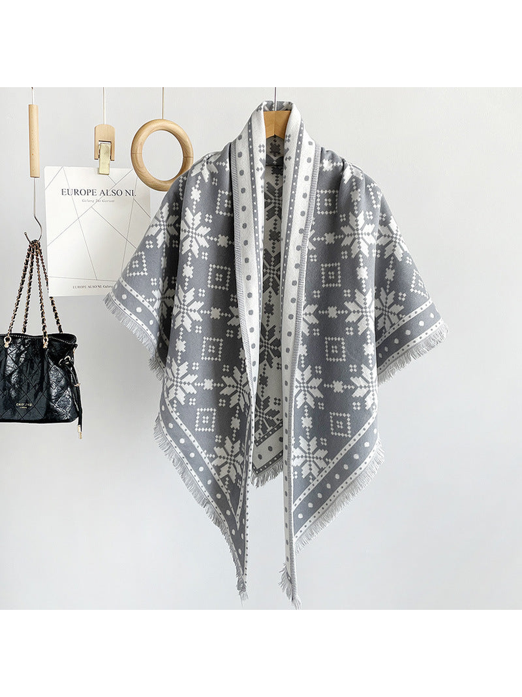 Gray snowflake triangle scarf draped on a hanger