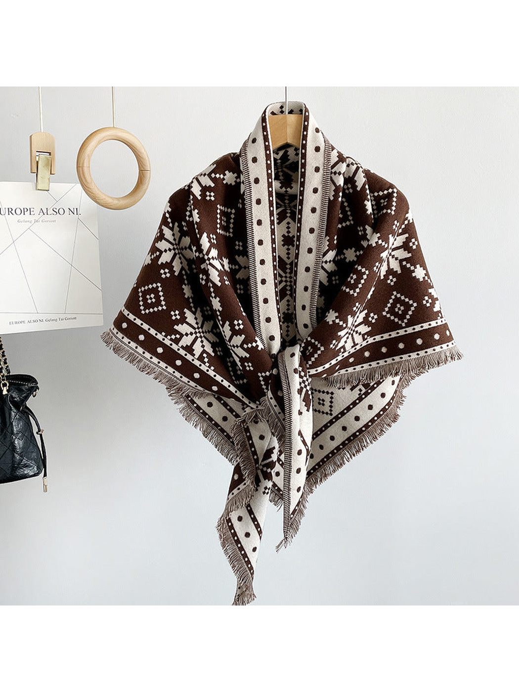 Dark Brown snowflake triangle scarf tied on a hanger