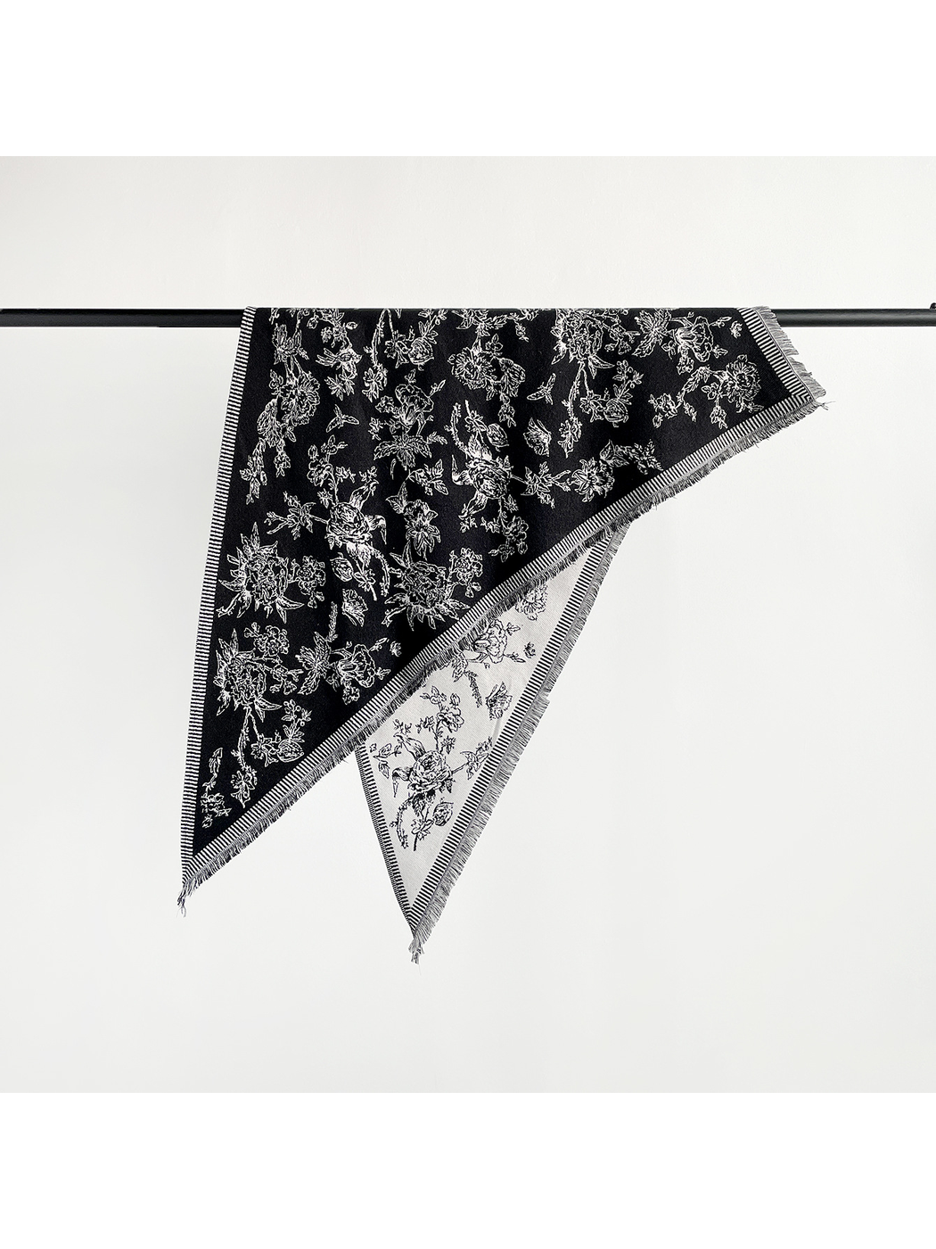 Black and ivory floral triangle scarf with striped border and short fringe