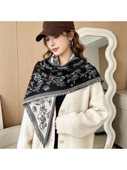 Black and ivory floral scarf styled over a cream cardigan