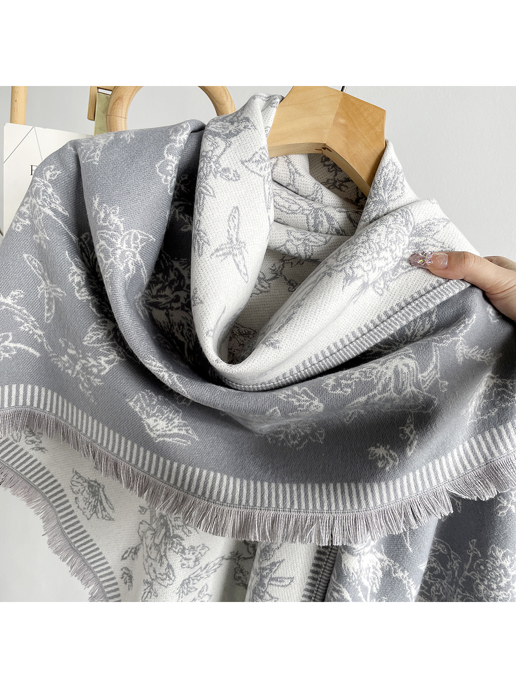 Close-up of the floral pattern, striped border and short fringe edging