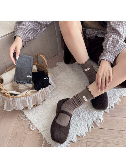 Coffee ruffle-cuff crew socks worn with brown Mary Jane shoes