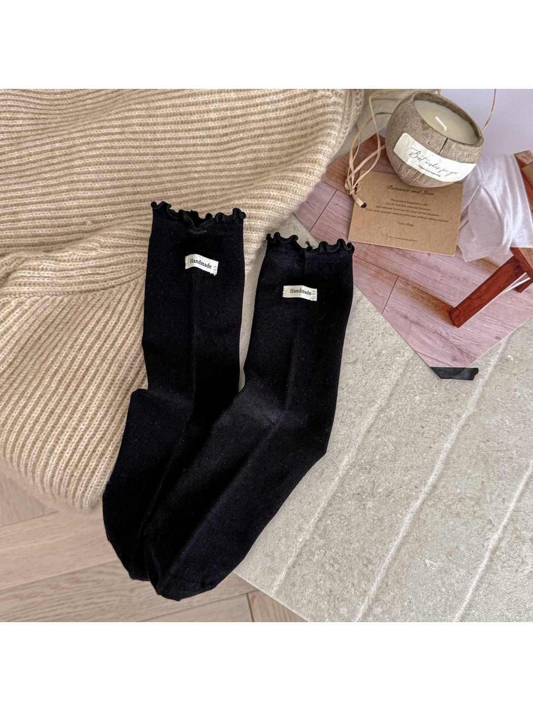 Black crew socks with ruffle cuffs and small fabric labels