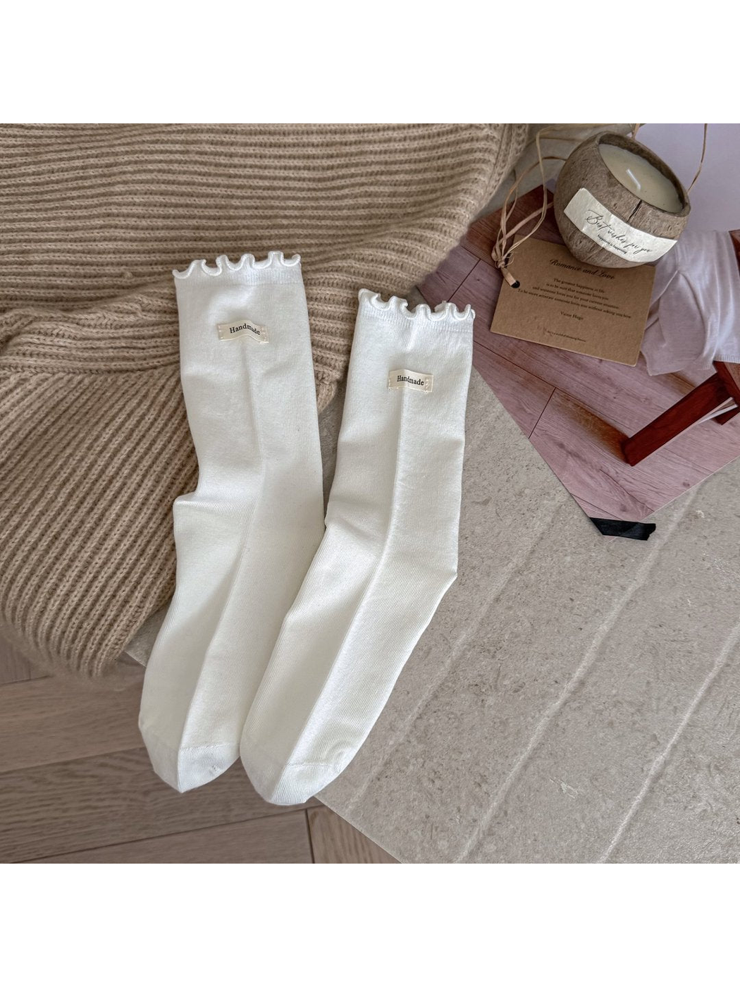 White crew socks with ruffle cuffs and small fabric labels