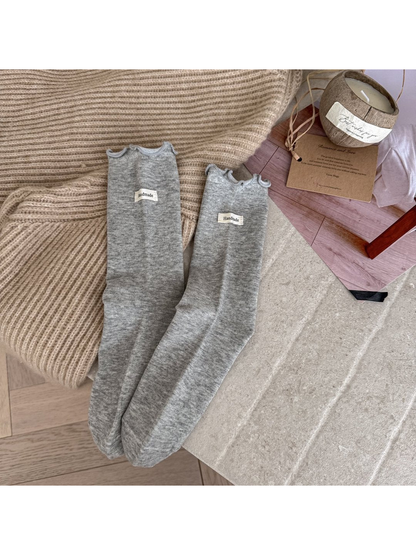 Light Gray crew socks with ruffle cuffs and small fabric labels