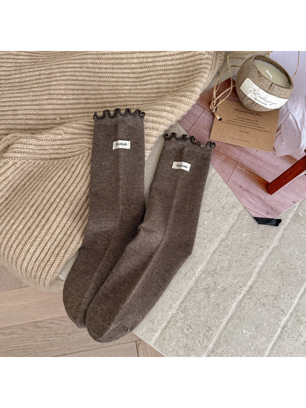 Coffee crew socks with dark-edged ruffle cuffs and small fabric labels