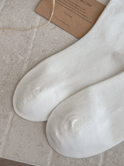 Close-up of rounded White sock toes with visible seams