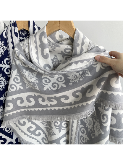 Close-up of the gray woven-look pattern, stitched border and short fringe